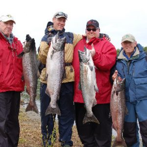 a group of clients poses with the salmon that they caught on alaska's nushagak river near our fishing lodge